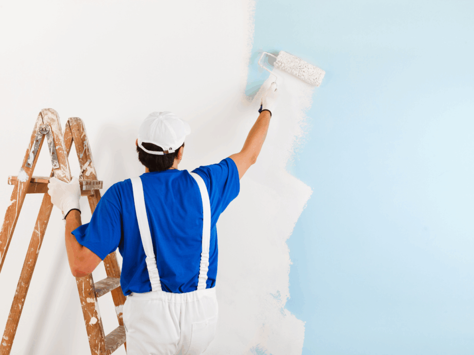 Painter Painting a wall white