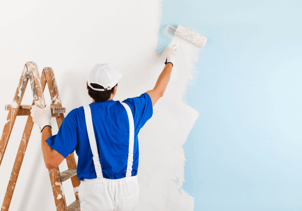 Painter Painting a wall white